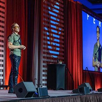 Dave Asprey Holiday Promotional image of Dave on Stage at Biohacking Conference