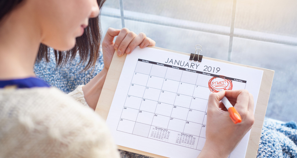 Woman writing in calendar