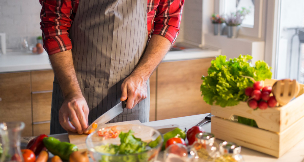 Man preparing vegetables in kitchen