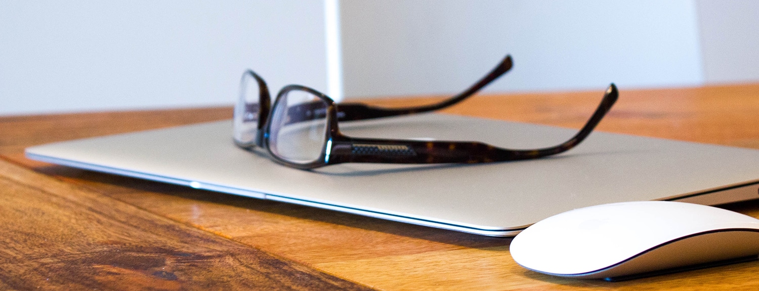 Reading glasses on closed laptop