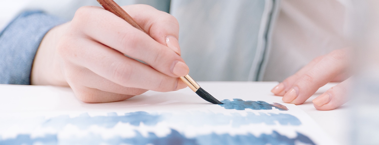 Woman painting with watercolors