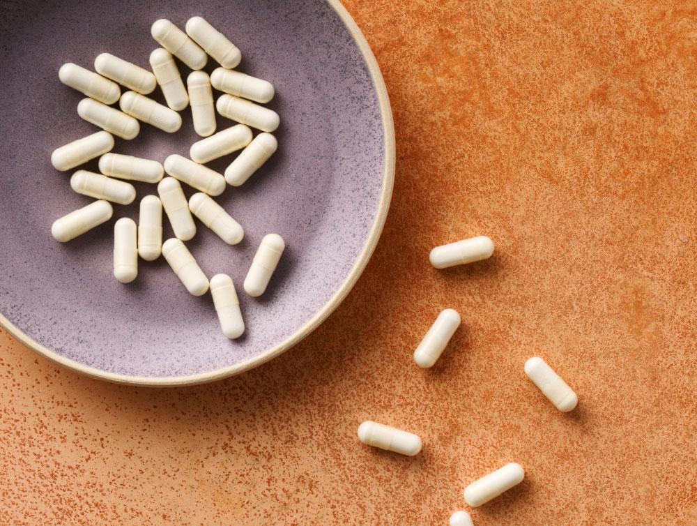 Pendulum Akkermansia Supplements in a brown bowl