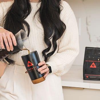 Danger Coffee Holiday Promotion image of woman pouring coffee into thermos