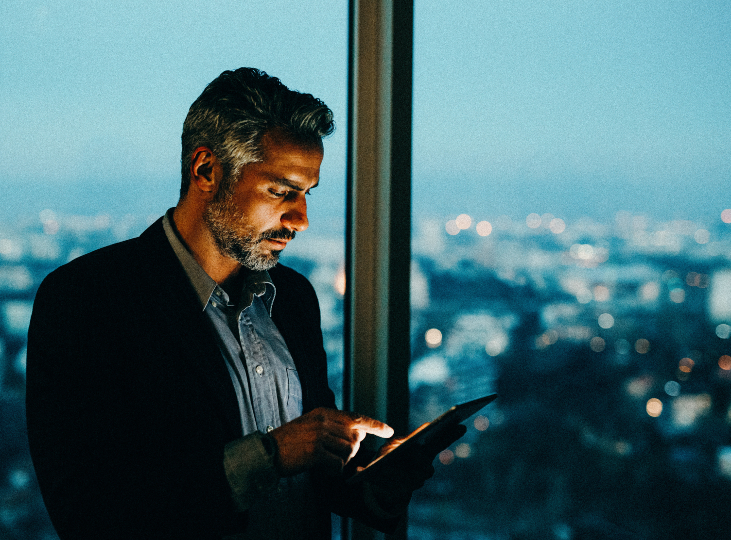 Buisnessman Using Tablet At Night