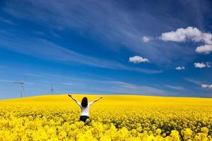 Happy young woman on spring field. Success, harmony, health, ecology photo