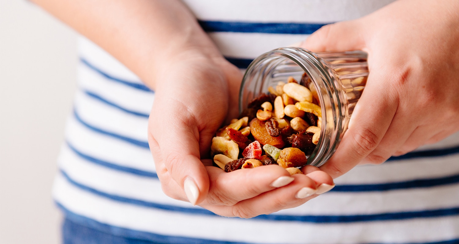 woman pouring snacks into her hand