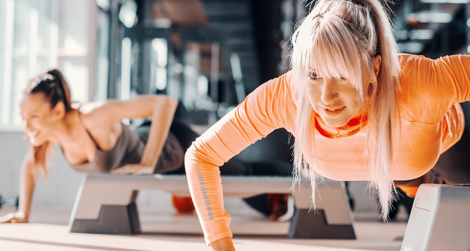 women doing push-ups at the gym