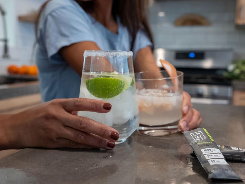 LMNT salt packet mixed with water in glass cups with salted rims