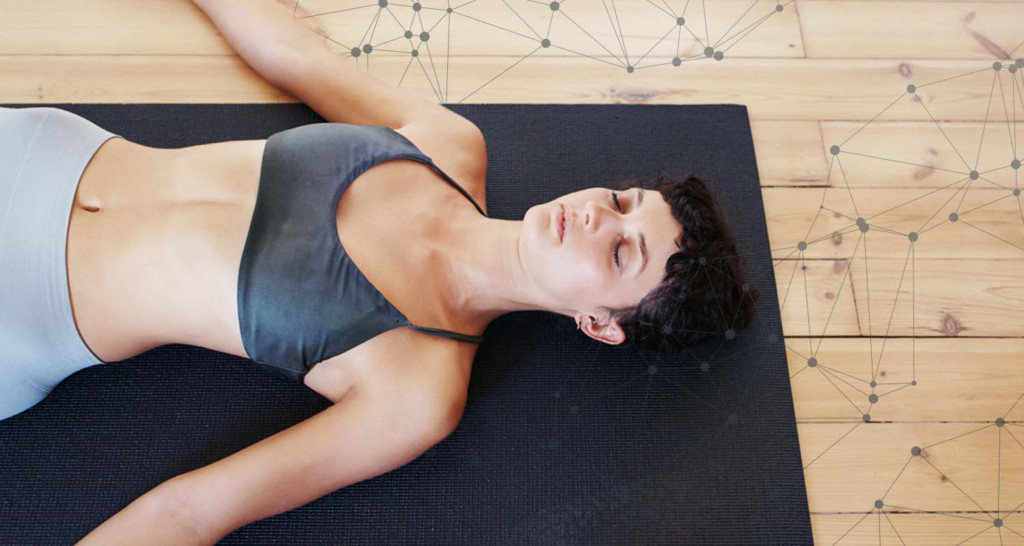 Woman meditating on wood floor