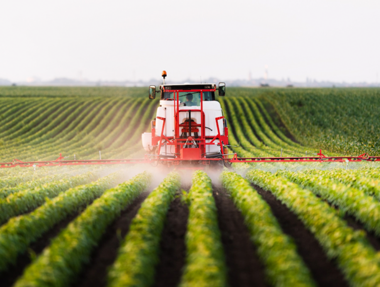 Tractor spraying crops