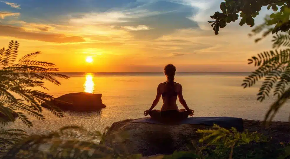 yoga-practicing-at-sunset-meditation-559454563